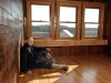 Gene Sigel sits on the red oak floor of what will become the tasting room for his Red Eagle Distillery in Harpersfield Township, Northeast Ohio. Sigel renovated an 1885 barn to house his distillery and tasting room, which is located on a farm next to his vineyard.